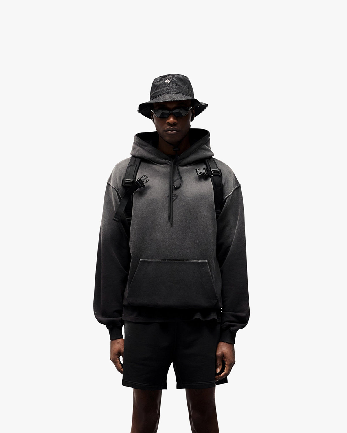 Man wearing an oversized black hoodie on a plain white background | 247 Motion Oversized Hoodie in Black | Oversized hoodie with ribbed hem and cuffs | 247 Hoodies | Represent Clo