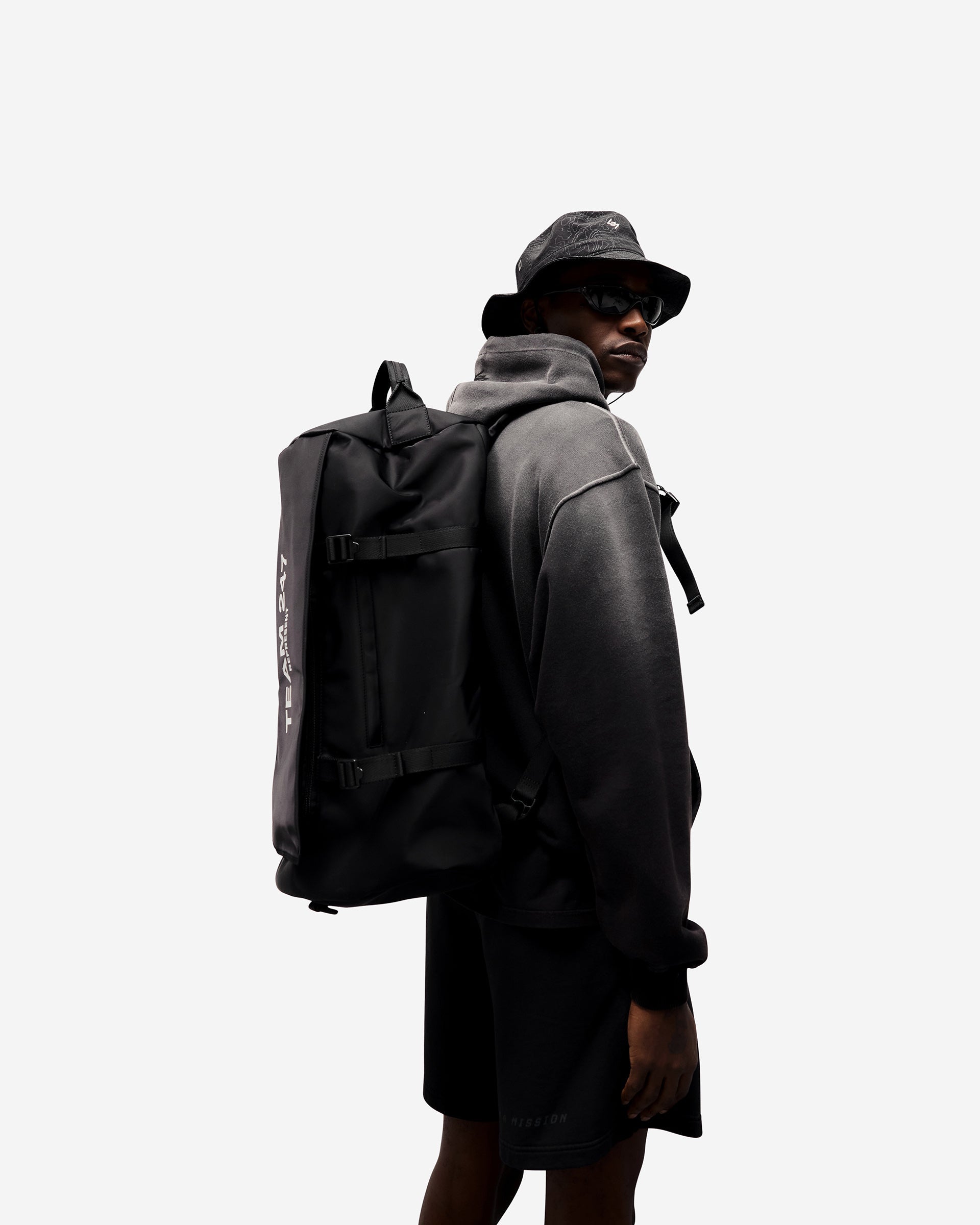 Back product image of a mens black bucket hat on a plain white background | 247 Contour Bucket Hat in Black | Ripstop fabric bucket hat with adjustable bungee and reflective design | 247 Accessories | Represent Clo