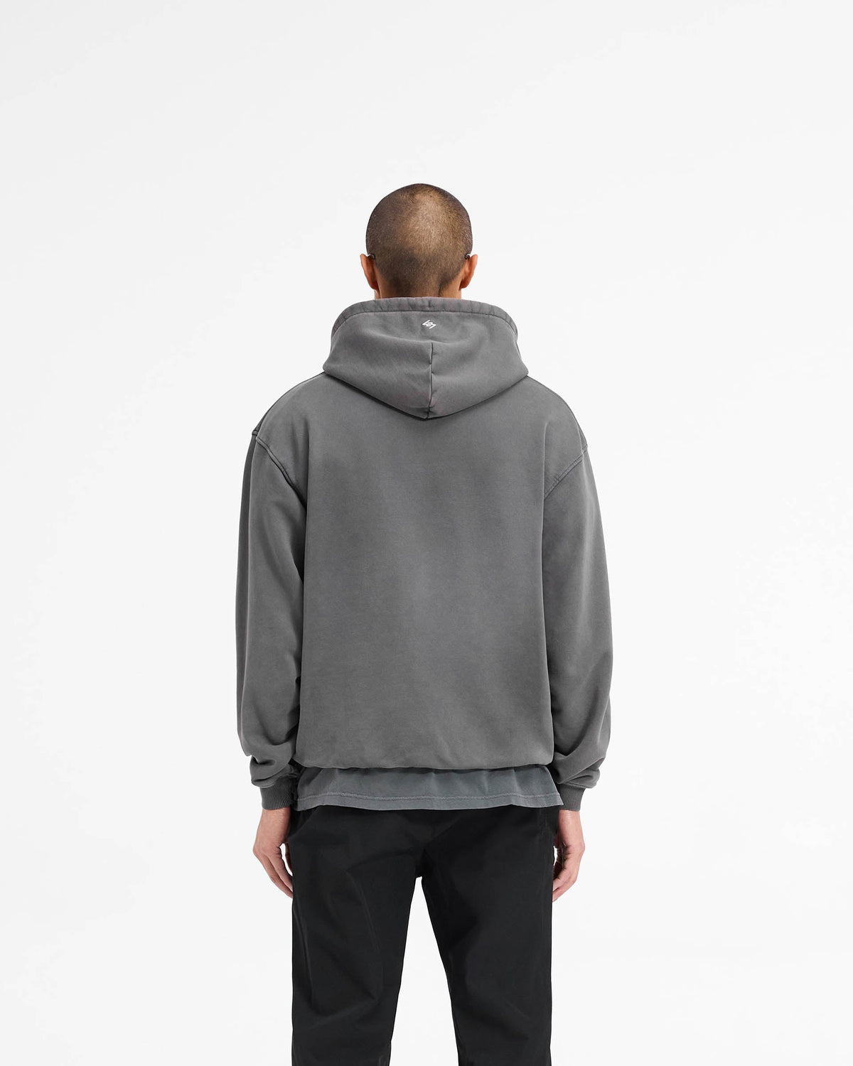 Man wearing a black hoodie on a plain white background | 247 On A Mission Hoodie in Aged Black | Slightly oversized hoodie with embroidery and ribbed trims | 247 Hoodies | Represent Clo
