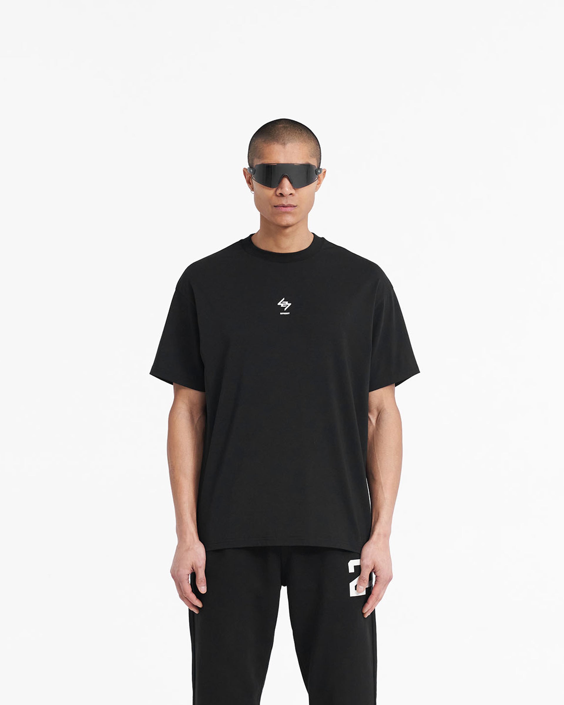 Man wearing an oversized black t-shirt on a plain white background | 247 Oversized T-Shirt in Jet Black | Quick dry oversized gym top | 247 T-Shirts | Represent Clo