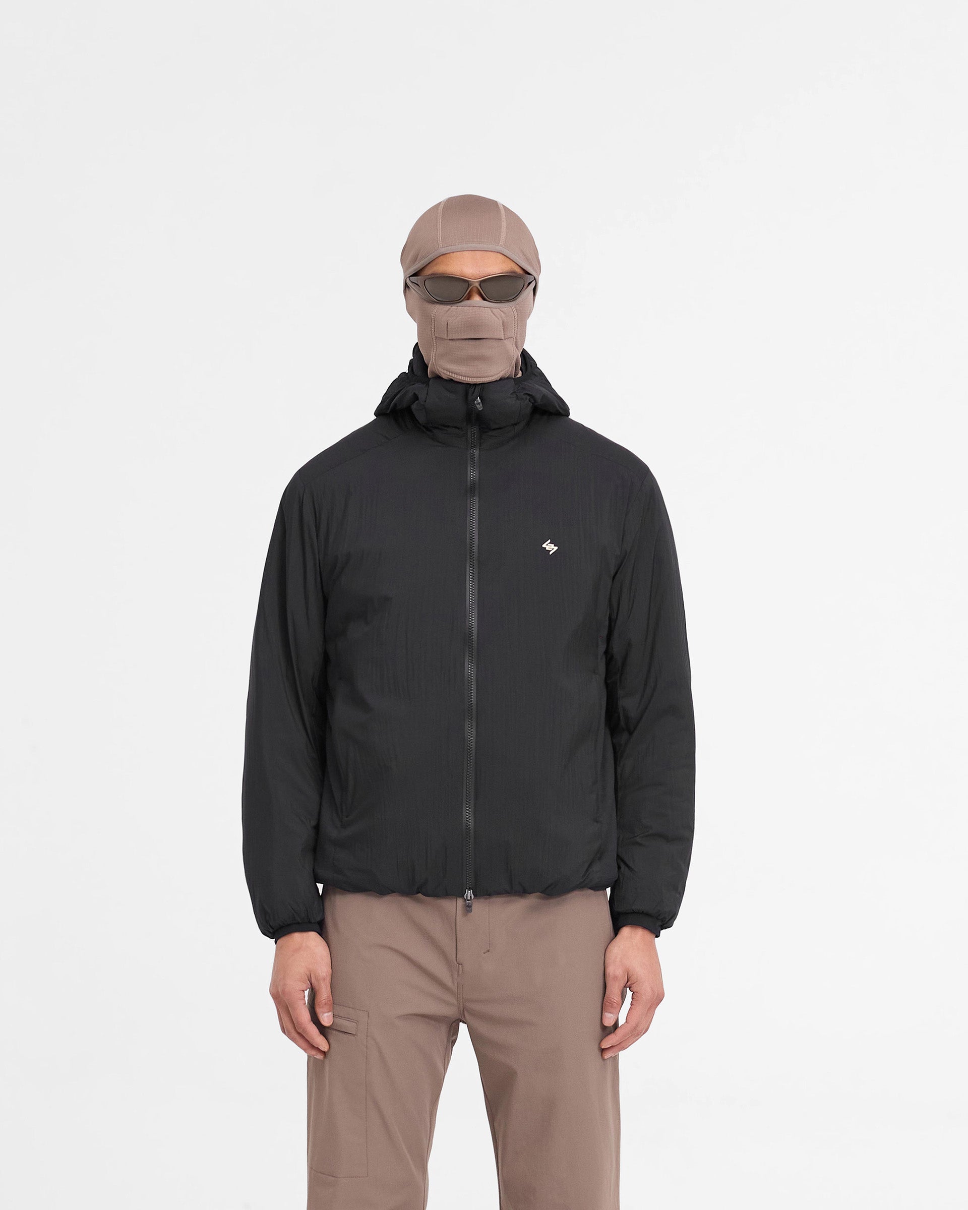 Man wearing a black insulated jacket on a plain white background | Team 247 Insulated Jacket in Black | Outerwear with adjustable hem and DWR coating | 247 Outerwear | Represent Clo