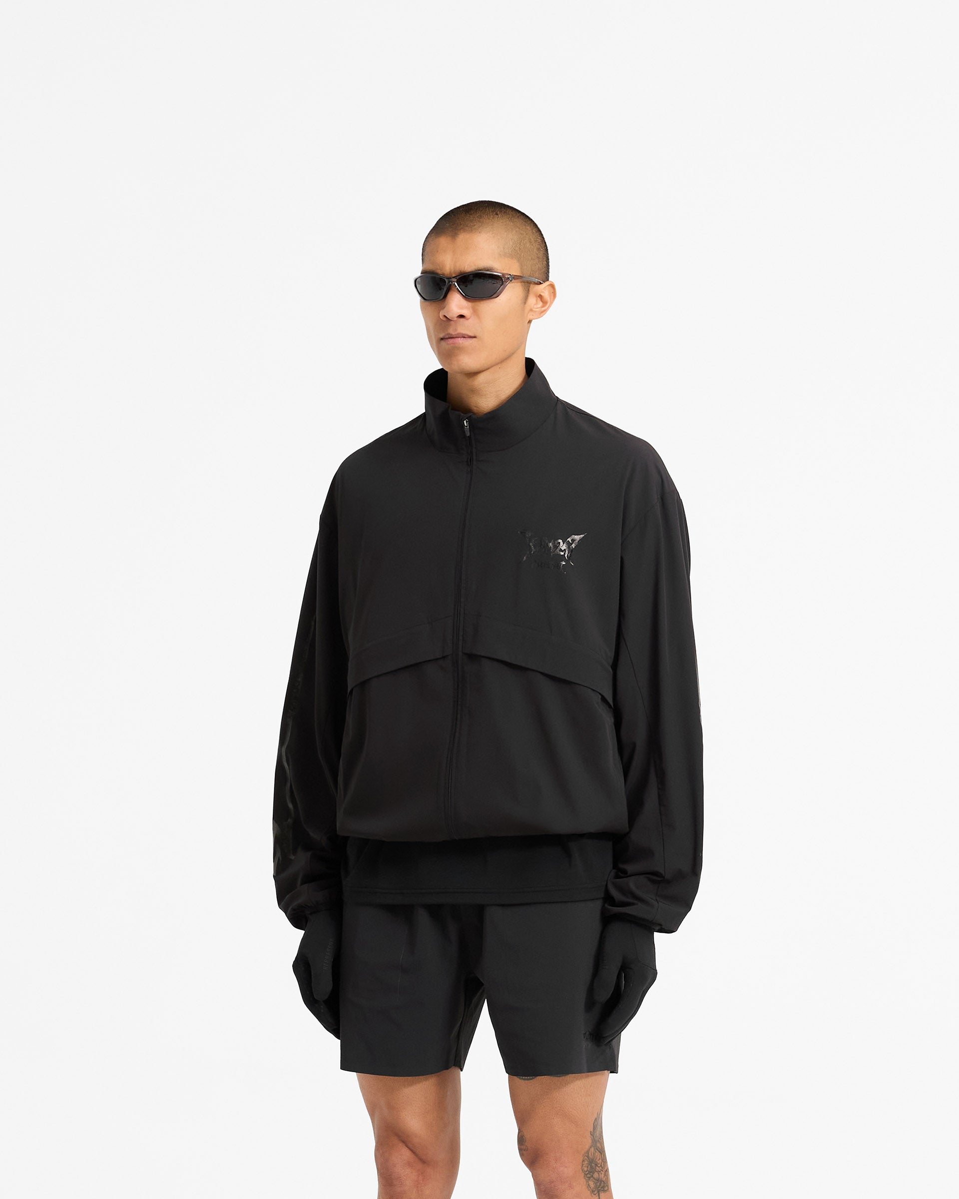 Back product image of a mens black track jacket on a plain white background | Team 247 X END Track Jacket in Jet Black | Track jacket with adjustable hem and elastic hand straps | 247 Outerwear | Represent Clo